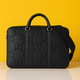 Monogram-embossed leather briefcase
